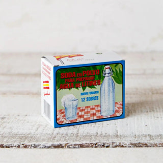 Foto frontal de una caja de soda en polvo para preparar agua de litines. Real Fábrica