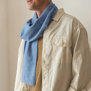 Foto mostrando uno de los extremos y los flecos de la bufanda de lana merino en color azul francia. Real Fábrica