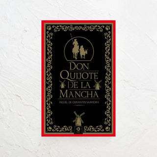 Don Quijote de la Mancha de la editorial EDIMAT en cuya portada se ve la silueta de Don Quijote y Sancho Panza en dorado. Real Fábrica