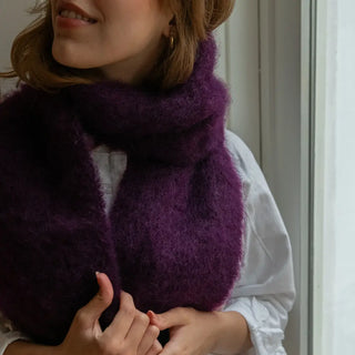 Mujer con un foulard de mohair alrededor del cuello. El mohair de Ezcaray es una fibra de gran calidad, suave y muy abrigada. Real Fábrica.