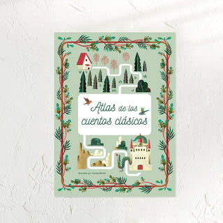 Libro Atlas de los Cuentos Clásicos. Portada dibujos de un castillo, una cas y un bosque. Real Fábrica.