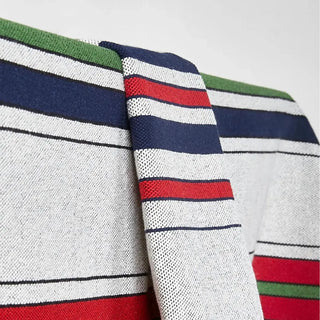 Foto mostrando detalladamente mantel tela canaria verde azul blanco. Real Fábrica.