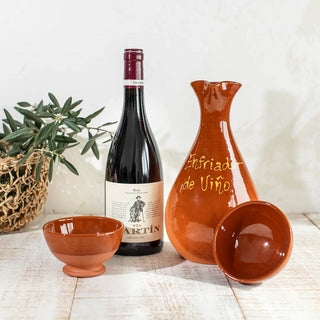 Pack de cerámica de barro gallego formado por un enfriador de vino, dos vasos y una botella de vino crianza. Real Fábrica