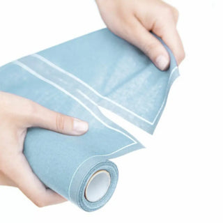 Se muestra cómo están precortadas las servilletas de este rollo de algodón azul niebla. Real Fábrica